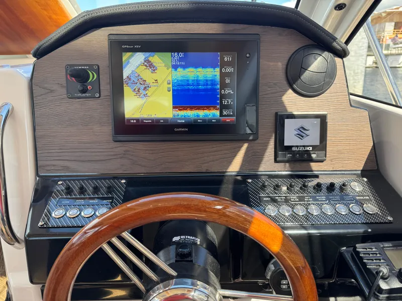 Slide: The Image of Dashboard of 2018 Cutwater C-242 Coupe with Garmin navigation and Suzuki controls. - 16