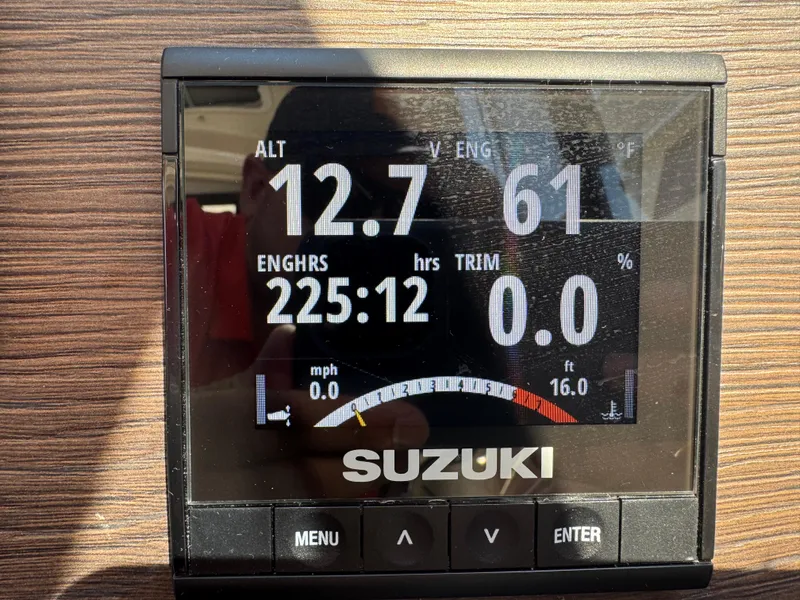 Slide: The Image of Suzuki engine display showing altitude, engine hours, and temperature on a 2018 Cutwater C-242 Coupe. - 17