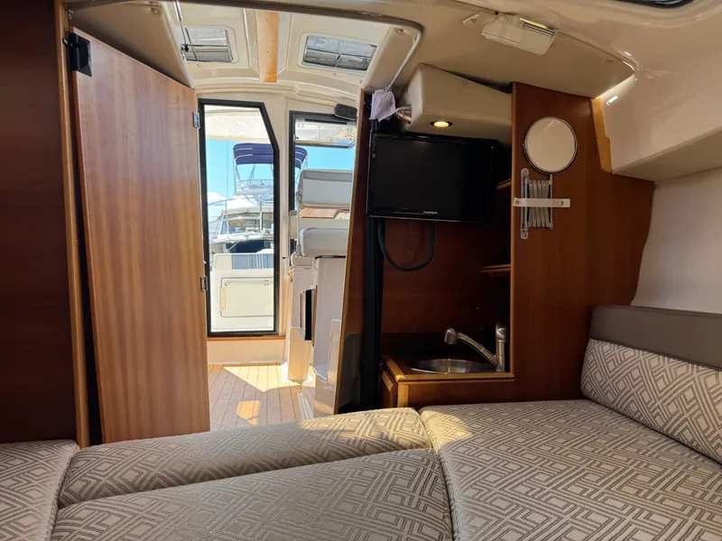 Slide: The Image of 2018 Cutwater C-242 Coupe interior with cozy cabin and kitchenette. - 21