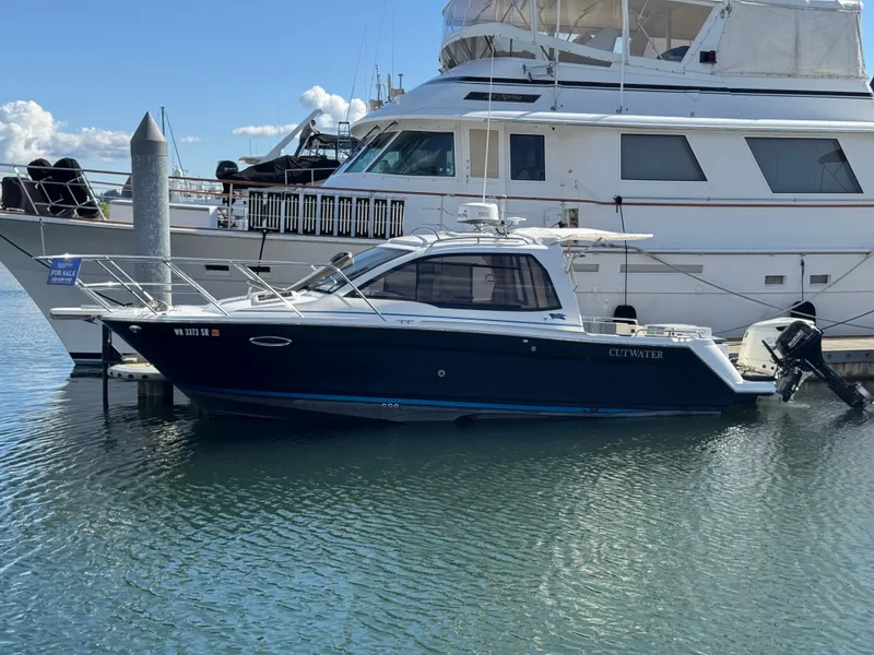 Slide: The Image of 2018 Cutwater C-242 Coupe boat docked beside a larger yacht. - 4