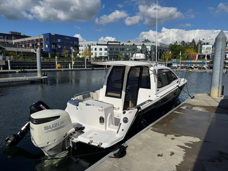 Slide: The Image of 2018 Cutwater C-242 Coupe boat docked at marina with Suzuki outboard motor. - 5