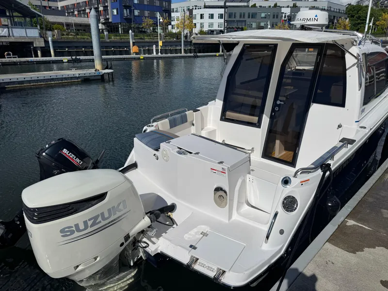 Slide: The Image of 2018 Cutwater C-242 Coupe docked, featuring Suzuki outboard motor, in a marina setting. - 6