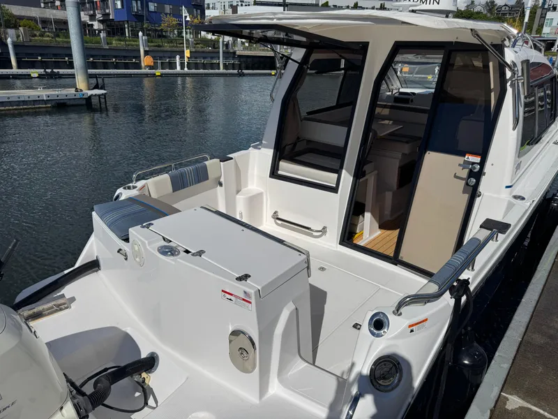 Slide: The Image of 2018 Cutwater C-242 Coupe boat docked at marina, showcasing open cockpit and cabin interior. - 7