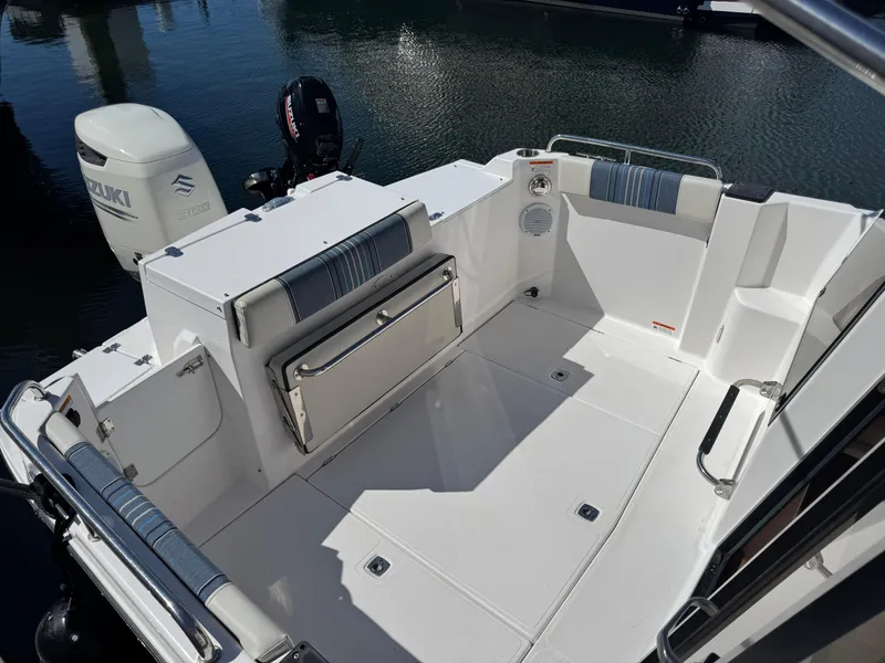 Slide: The Image of 2018 Cutwater C-242 Coupe boat deck with seating and Suzuki outboard motor. - 8