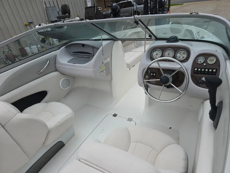 Slide: The Image of 2007 Chaparral 190 SSi boat interior with white seating and dashboard controls. - 10