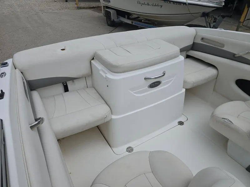 Slide: The Image of 2007 Chaparral 190 SSi boat interior with white seating and storage compartment. - 11