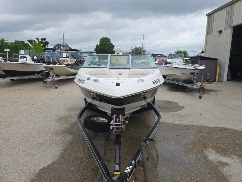 Slide: The Image of 2007 Chaparral 190 SSi boat on trailer, parked outdoors near other boats. - 8