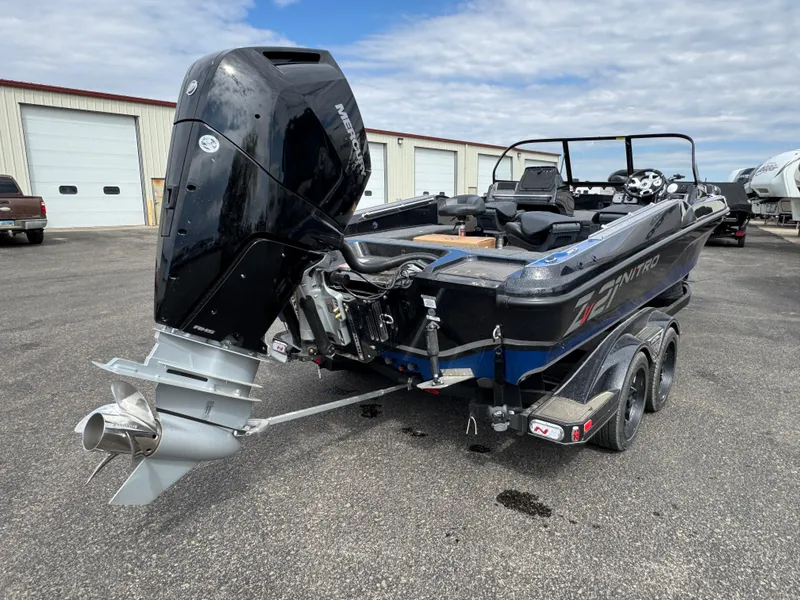 Slide: The Image of 2025 Nitro ZV21 Pro boat with powerful outboard motor, parked on a trailer. - 3