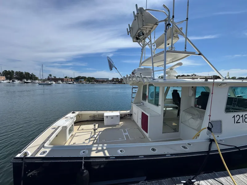 Slide: The Image of 2009 Northern Bay 36 boat docked at a marina under a clear blue sky. - 10