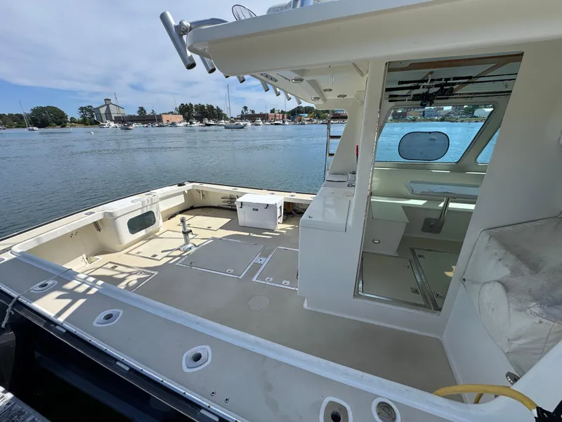 Slide: The Image of 2009 Northern Bay 36 boat with spacious deck and cabin, docked by the waterfront. - 13