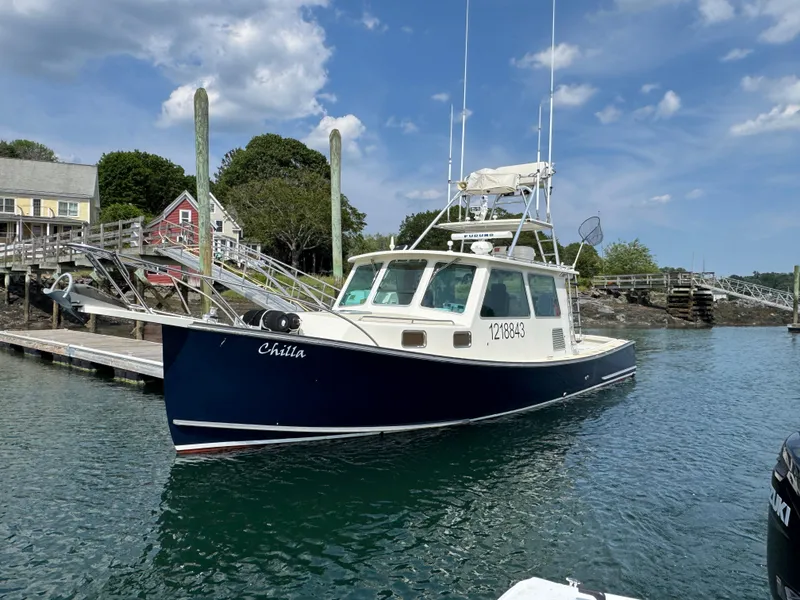 Slide: The Image of 2009 Northern Bay 36 boat docked in a scenic harbor with blue skies. - 3