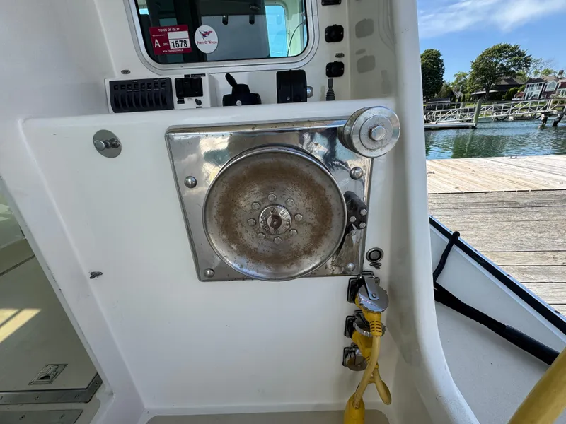 Slide: The Image of 2009 Northern Bay 36 boat interior with control panel and winch near dock. - 34