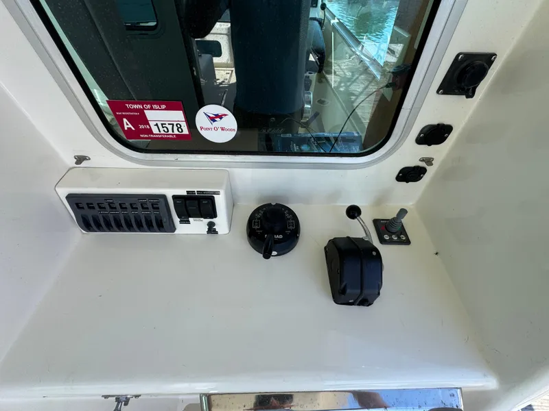 Slide: The Image of Control panel of a 2009 Northern Bay 36 boat with switches and levers. - 35