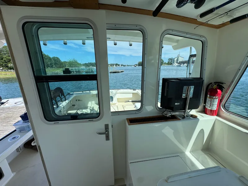 Slide: The Image of Interior view of 2009 Northern Bay 36 boat with water and dock visible through windows. - 38