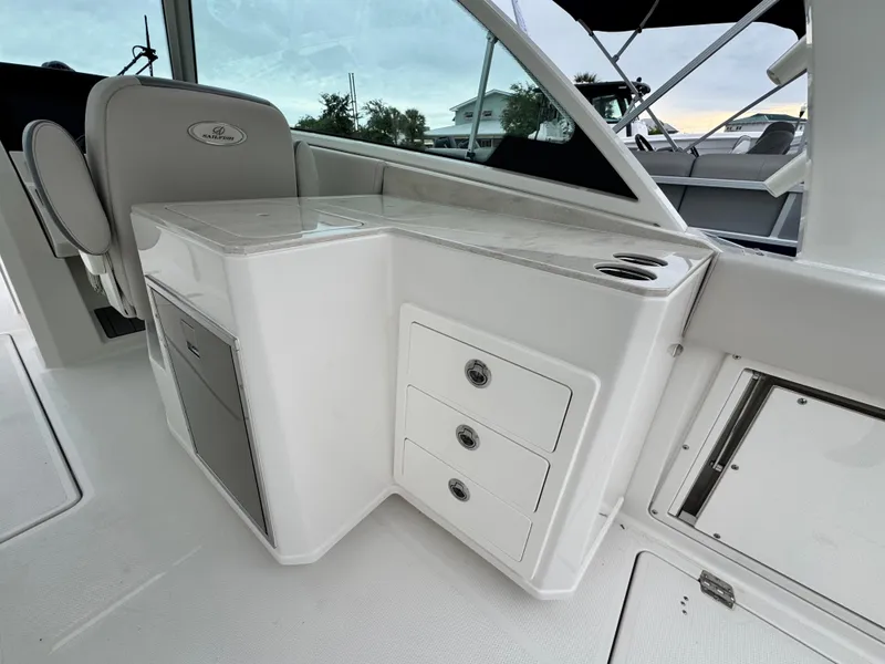 Slide: The Image of 2025 Sailfish 316 DC boat interior with storage drawers and seating area. - 19