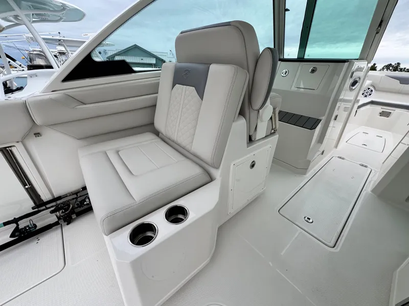 Slide: The Image of Luxurious seating on 2025 Sailfish 316 DC boat with cup holders and modern design. - 20