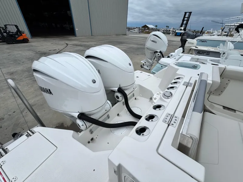 Slide: The Image of 2025 Sailfish 316 DC boat with dual Yamaha outboard engines at a marina. - 23