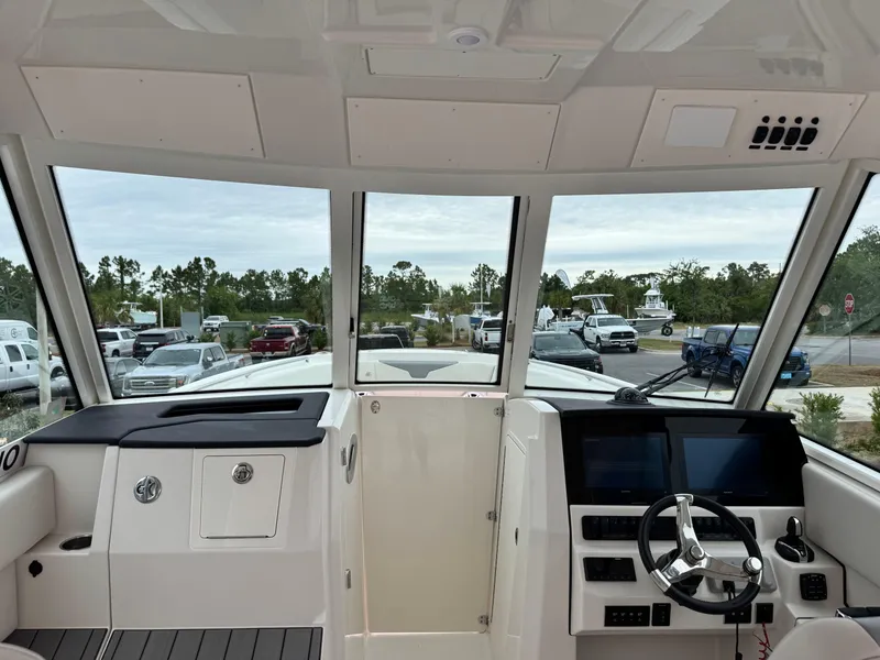 Slide: The Image of Interior view of 2025 Sailfish 316 DC boat cockpit with steering wheel and dashboard. - 26