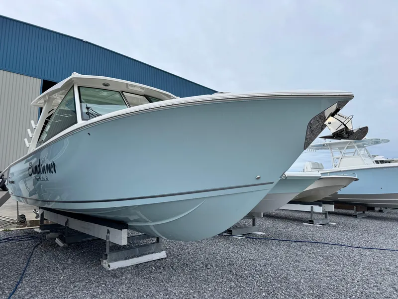 Slide: The Image of 2025 Sailfish 316 DC boat on display in a marina setting. - 3