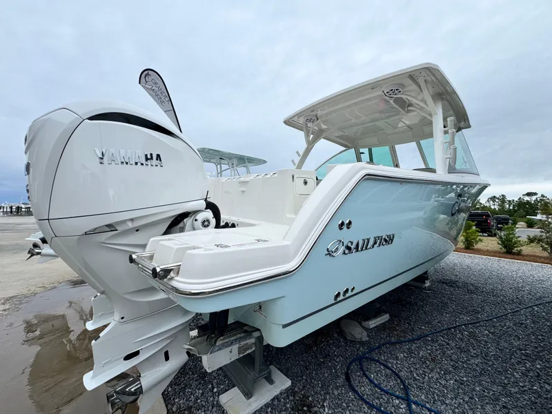 Slide: The Image of 2025 Sailfish 316 DC boat with Yamaha engine, displayed on gravel surface. - 4