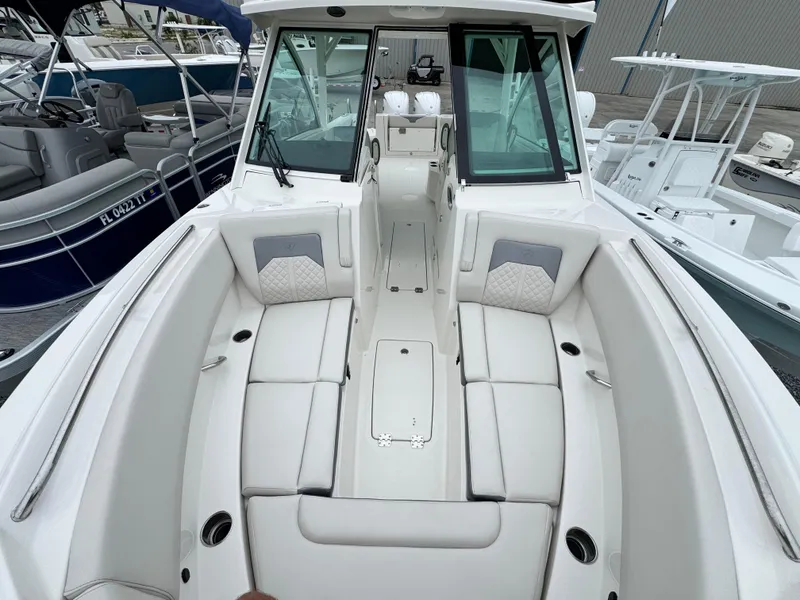 Slide: The Image of 2025 Sailfish 316 DC boat interior with white seating and modern design. - 7