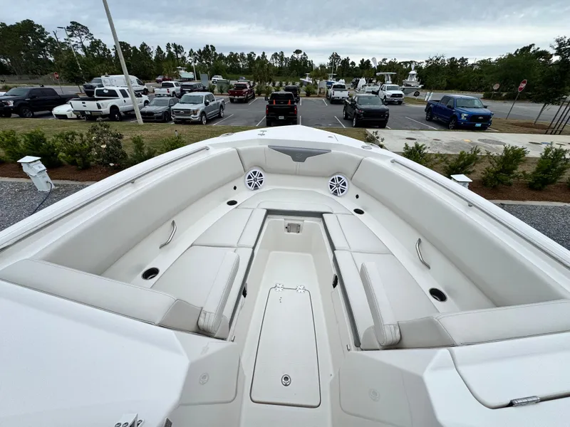 Slide: The Image of 2025 Sailfish 316 DC boat interior with spacious seating and modern design in a parking lot. - 8