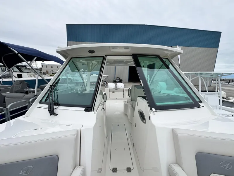 Slide: The Image of 2025 Sailfish 316 DC boat with sleek design, docked at marina. - 9