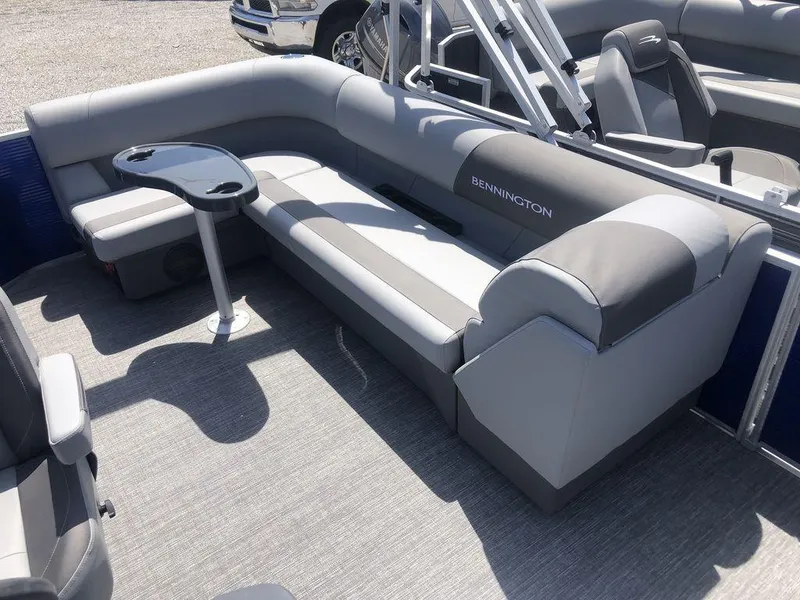 Slide: The Image of 2025 Bennington S L-Bench 20 SL pontoon boat interior with gray seating and table. - 3