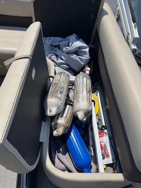 Slide: The Image of Storage compartment of a 2018 Sun Tracker Bass Buggy 16 DLX with boating equipment. - 10