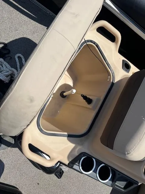 Slide: The Image of 2018 Sun Tracker Bass Buggy 16 DLX boat interior with storage compartment and cup holders. - 11