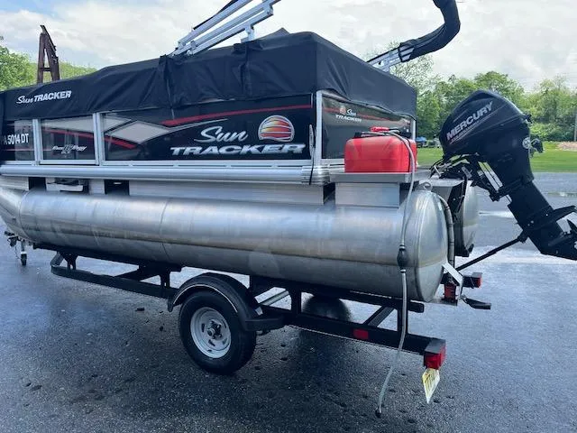 Slide: The Image of 2018 Sun Tracker Bass Buggy 16 DLX pontoon boat with Mercury outboard motor on trailer. - 13