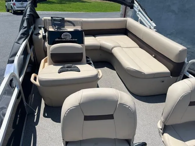 Slide: The Image of 2018 Sun Tracker Bass Buggy 16 DLX interior with beige seating and steering console. - 4