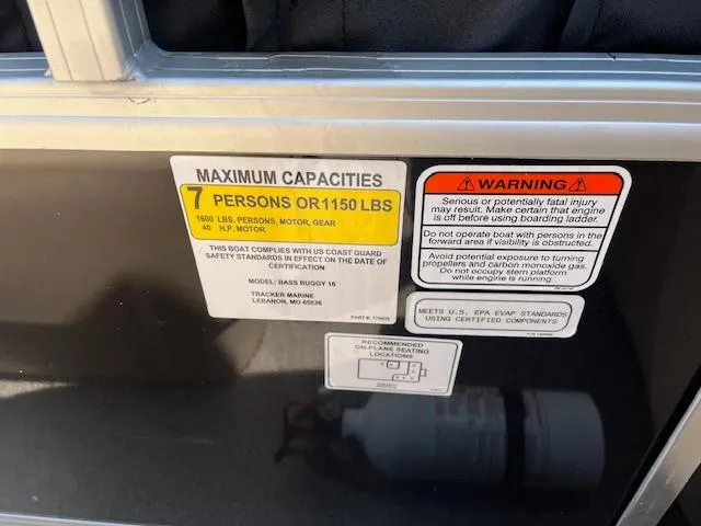 Slide: The Image of 2018 Sun Tracker Bass Buggy 16 DLX capacity warning labels, 7 persons or 1150 lbs limit. - 6