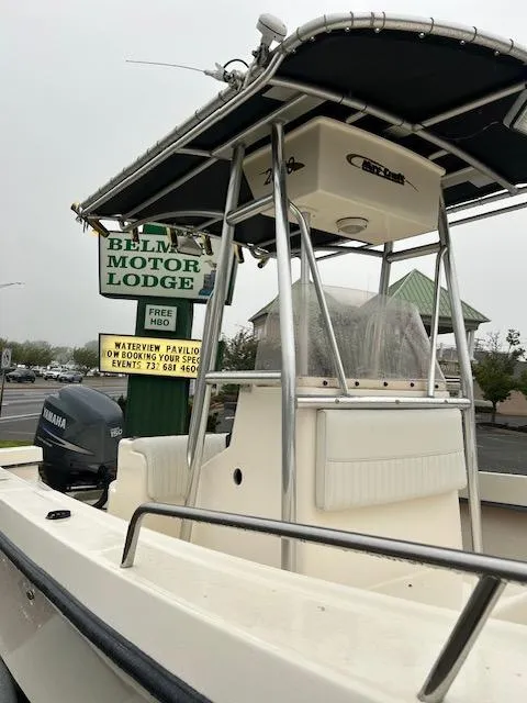 Slide: The Image of 2007 May-Craft 2300CC boat with Yamaha motor, parked near Belmar Motor Lodge sign. - 3