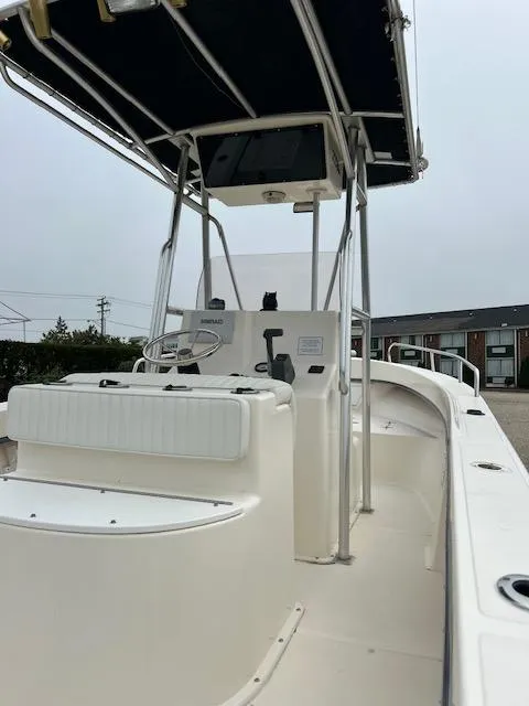 Slide: The Image of 2007 May-Craft 2300CC boat with center console and canopy, docked outdoors. - 6