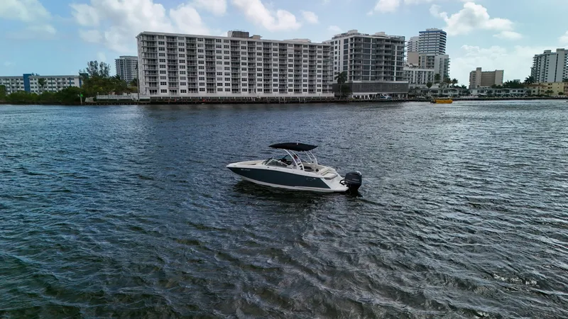 Slide: The Image of 2021 Cobalt 25SC boat on water with cityscape background. - 18