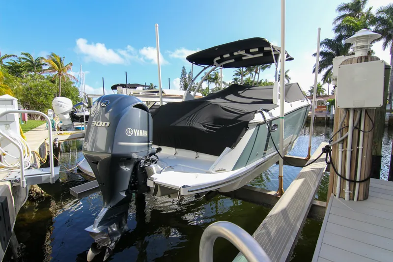 Slide: The Image of 2021 Cobalt 25SC boat with Yamaha 300 engine docked in a sunny marina. - 24