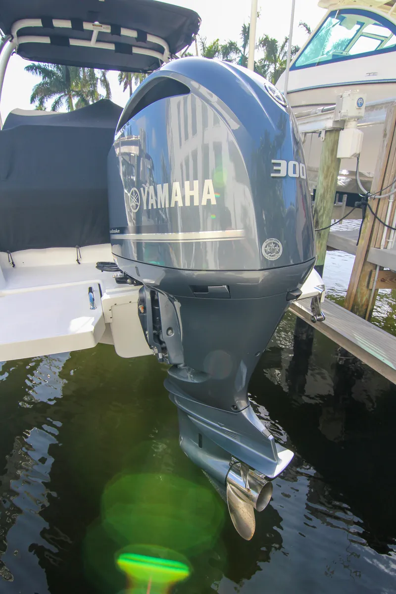 Slide: The Image of 2021 Cobalt 25SC boat with Yamaha 300 outboard motor docked by water. - 27