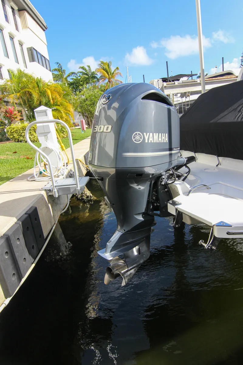 Slide: The Image of 2021 Cobalt 25SC boat with Yamaha 300 outboard motor docked by a sunny waterfront. - 28
