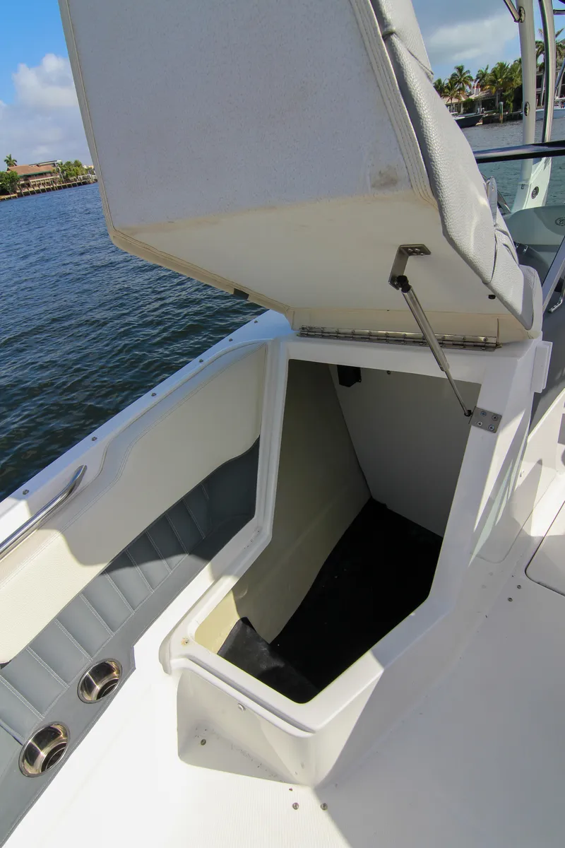 Slide: The Image of 2021 Cobalt 25SC boat with open storage compartment by the water. - 31