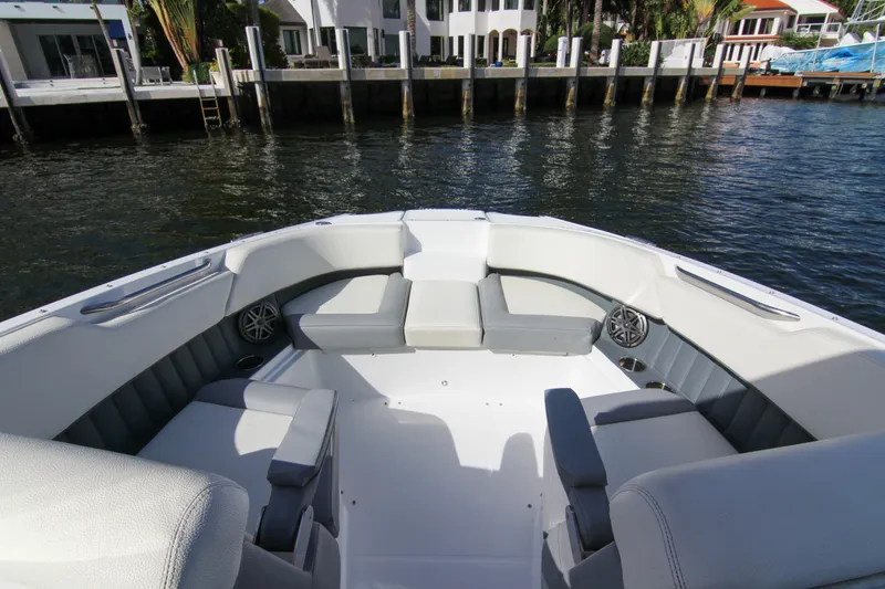 Slide: The Image of 2021 Cobalt 25SC boat interior with spacious seating, dockside view. - 32