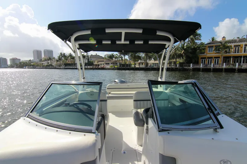 Slide: The Image of 2021 Cobalt 25SC boat on water, featuring open cockpit and waterfront view. - 35