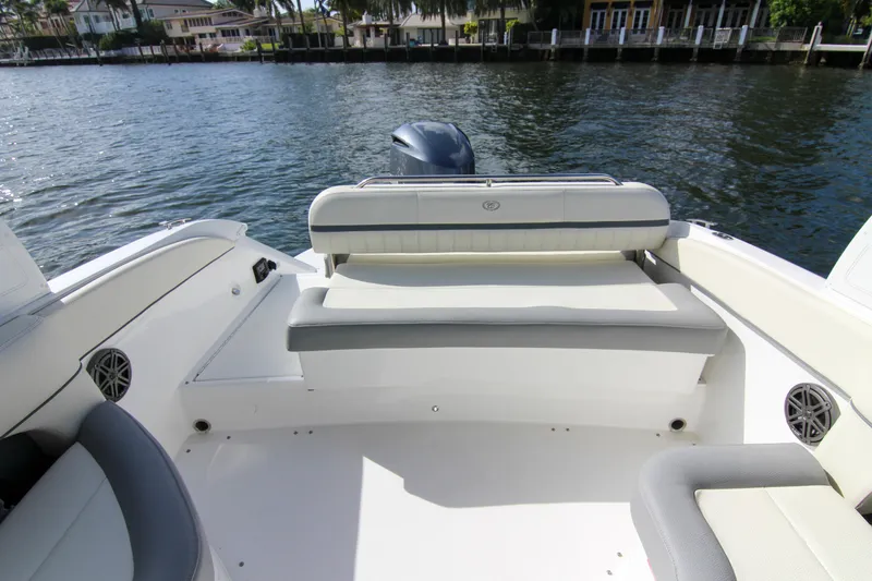 Slide: The Image of 2021 Cobalt 25SC boat interior with seating, overlooking calm waterfront. - 36