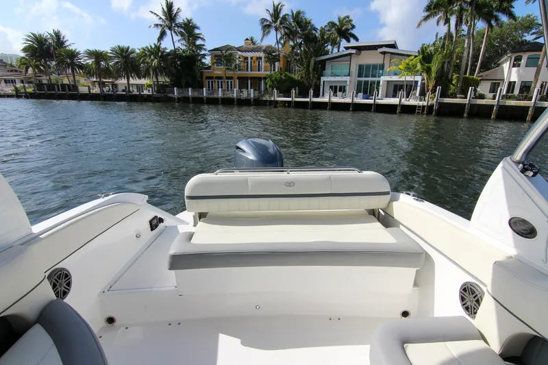 Slide: The Image of 2021 Cobalt 25SC boat on water, with luxurious waterfront homes in the background. - 38