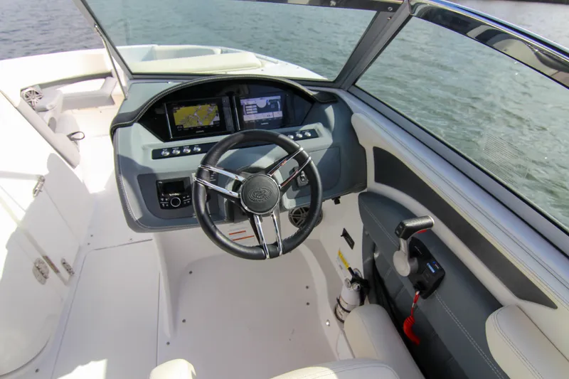 Slide: The Image of 2021 Cobalt 25SC boat cockpit with steering wheel and navigation screens. - 43