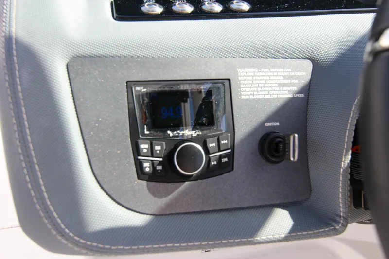 Slide: The Image of Control panel of a 2021 Cobalt 25SC boat with audio system and ignition switch. - 46