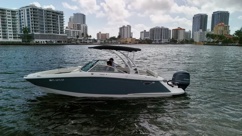 Slide: The Image of 2021 Cobalt 25SC boat on water with city skyline in background. - 5