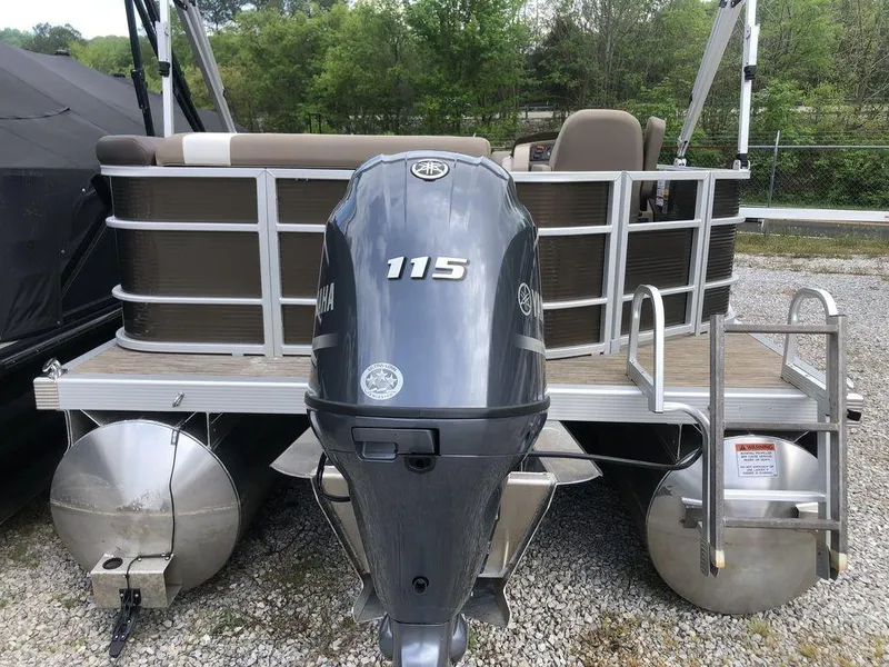 Slide: The Image of 2023 Bennington 21 SXL pontoon boat with Yamaha 115 engine, parked on gravel. - 6