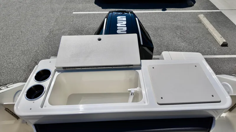 Slide: The Image of Bayliner Trophy 23 Pilothouse 2025 boat with open storage compartments and engine view. - 17