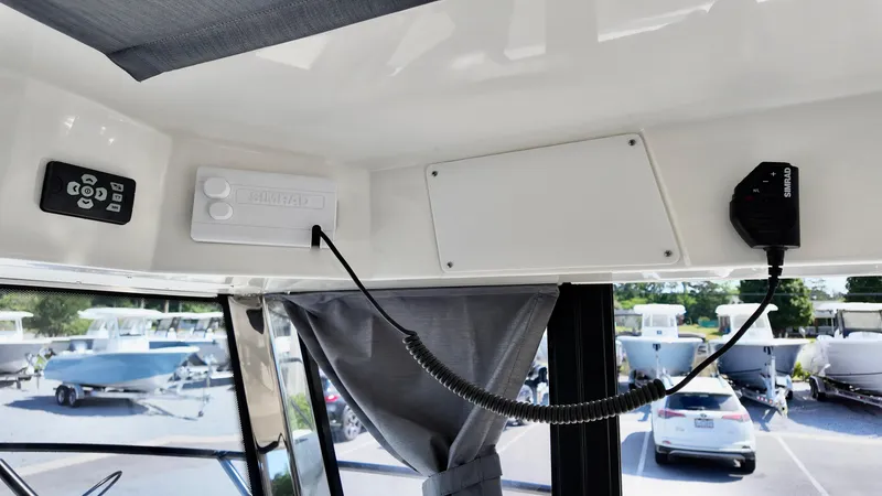 Slide: The Image of 2025 Bayliner Trophy 23 Pilothouse interior with control panel and communication equipment. - 20
